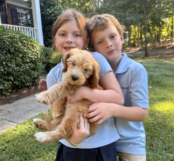 Adams Farm forever family with their puppy
